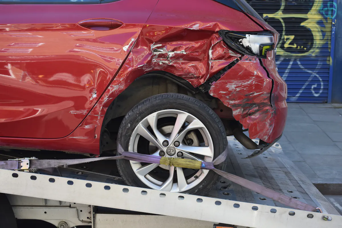 A damaged vehicle on a recovery truck